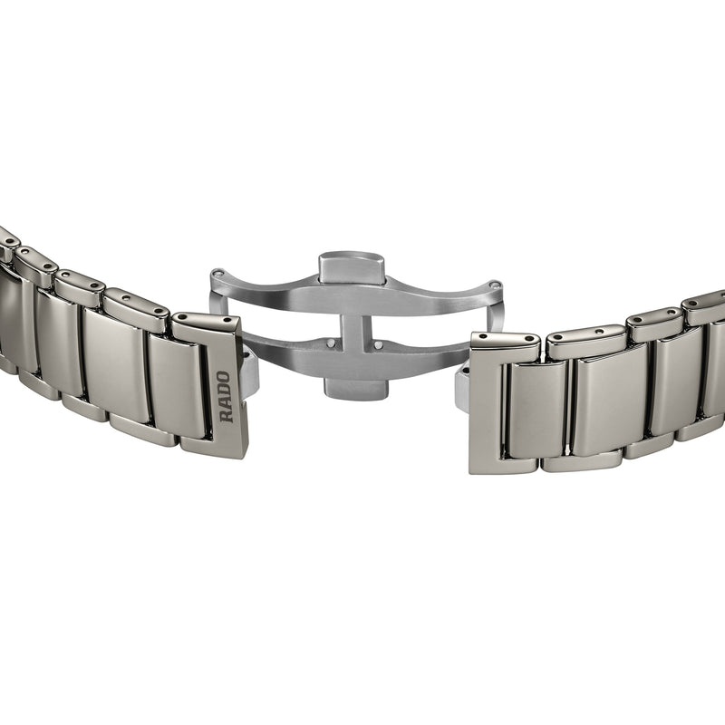 Polished silver-grey titanium Rado watch bracelet, showing the open triple folding clasp mechanism.