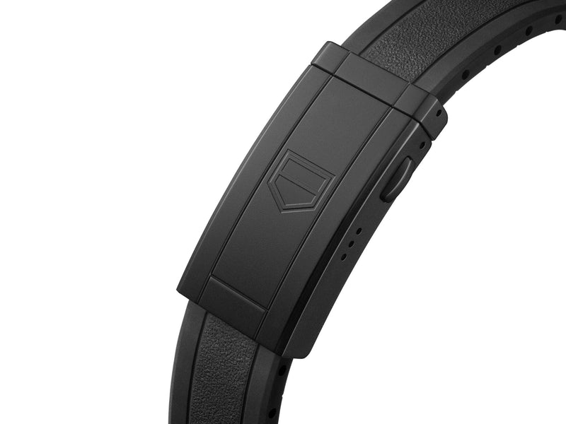 TAG Heuer Aquaracer black rubber strap and folding clasp. Close-up shows textured rubber and embossed logo.