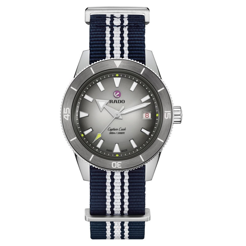Rado Captain Cook watch with grey dial, stainless steel case, and a blue and white striped NATO strap.