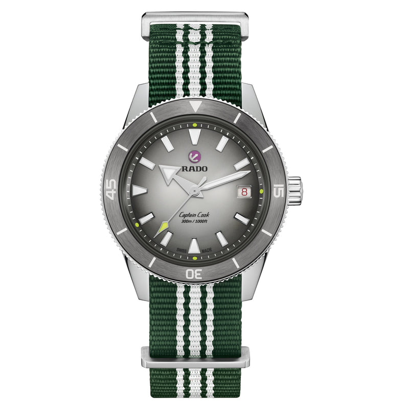 Rado Captain Cook diver's watch with grey gradient dial, silver case, and a green NATO strap with white racing stripes.