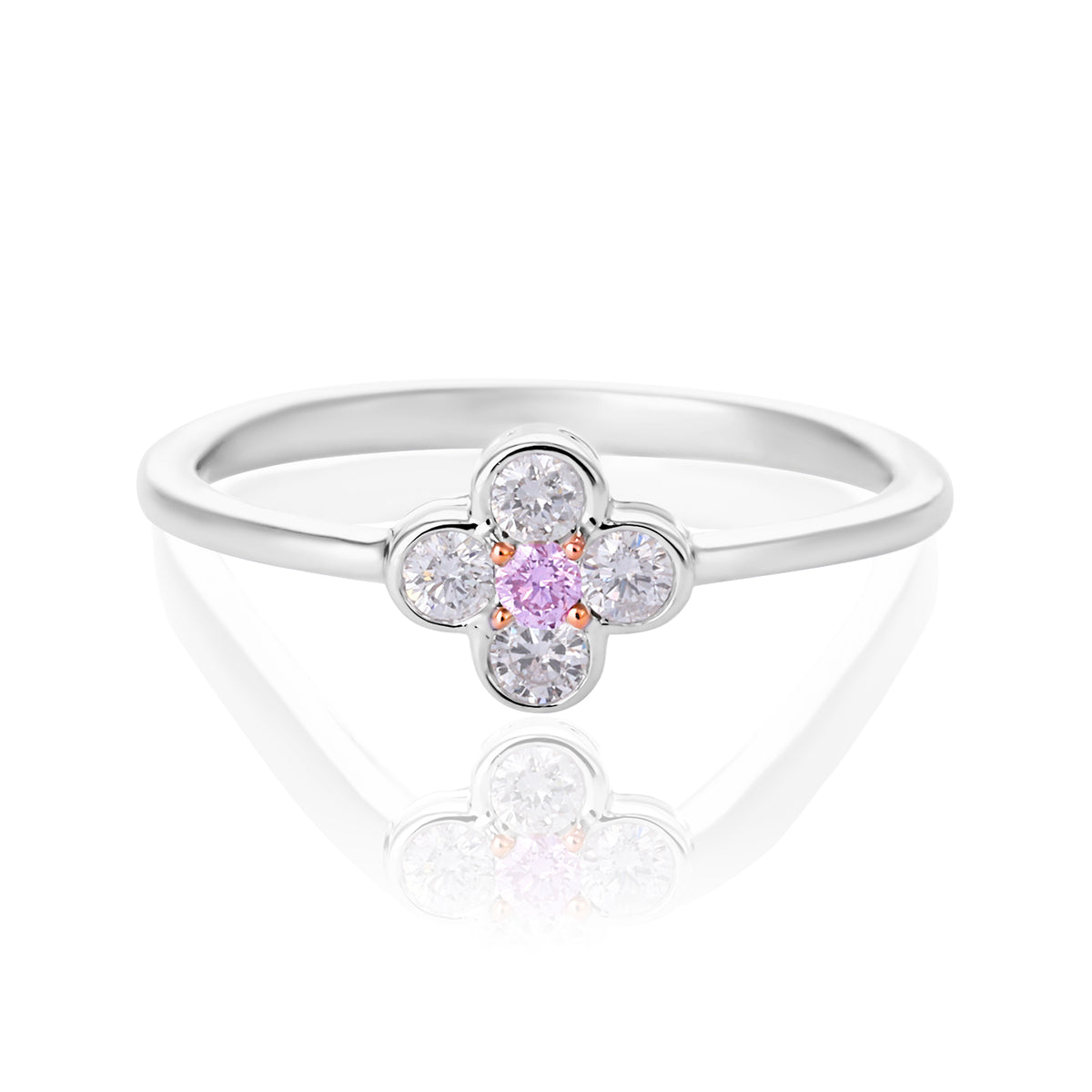 A pink diamond flower ring featuring a central round pink gemstone surrounded by four clear round-cut stones, set on a polished silver band, shown on a white reflective background.