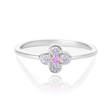 A pink diamond flower ring featuring a central round pink gemstone surrounded by four clear round-cut stones, set on a polished silver band, shown on a white reflective background.
