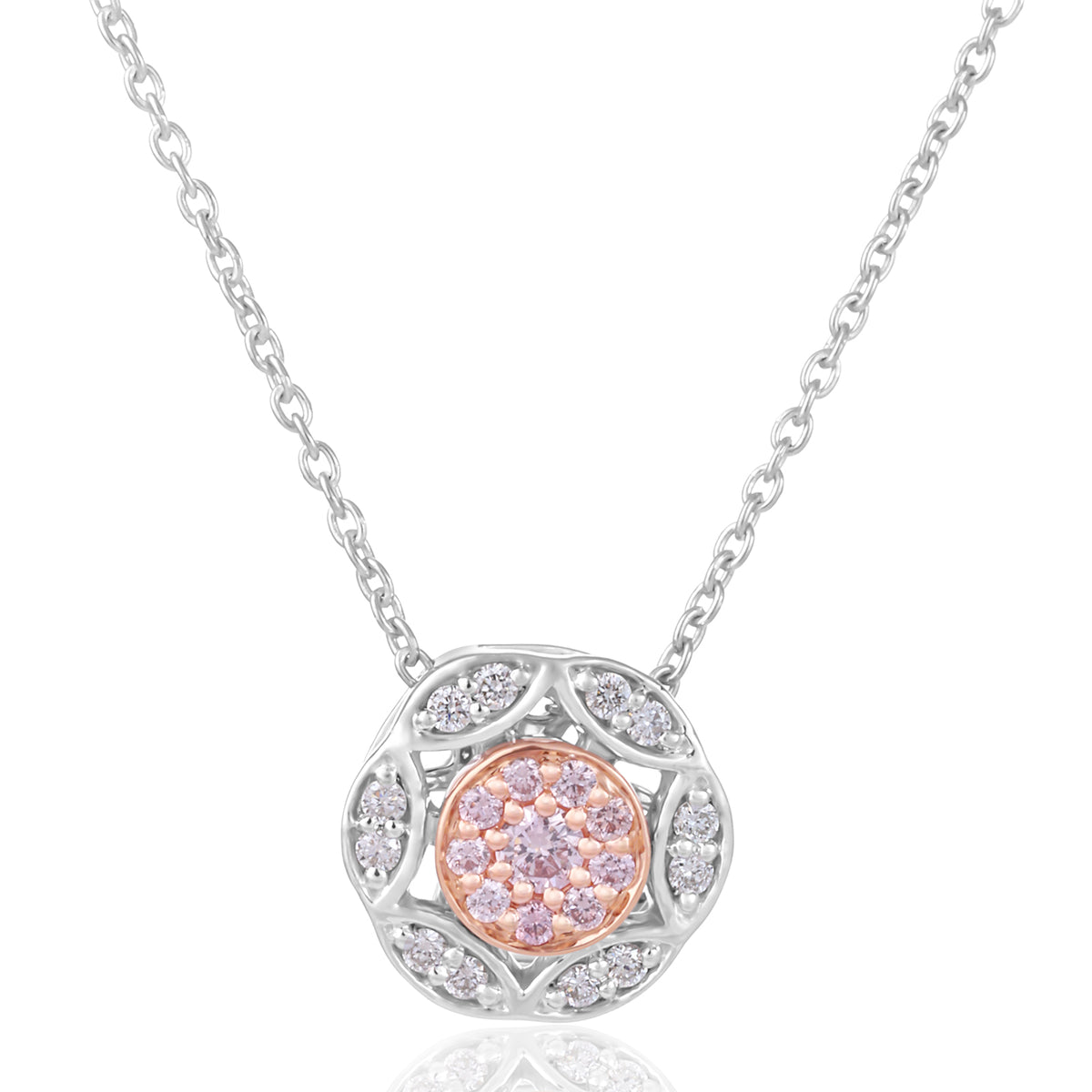 A pendant necklace featuring a circular floral design with a central cluster of pink gemstones surrounded by small clear stones, suspended from a delicate silver chain on a white background.