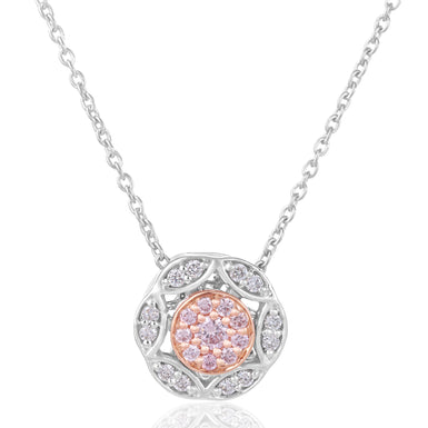 A pendant necklace featuring a circular floral design with a central cluster of pink gemstones surrounded by small clear stones, suspended from a delicate silver chain on a white background.