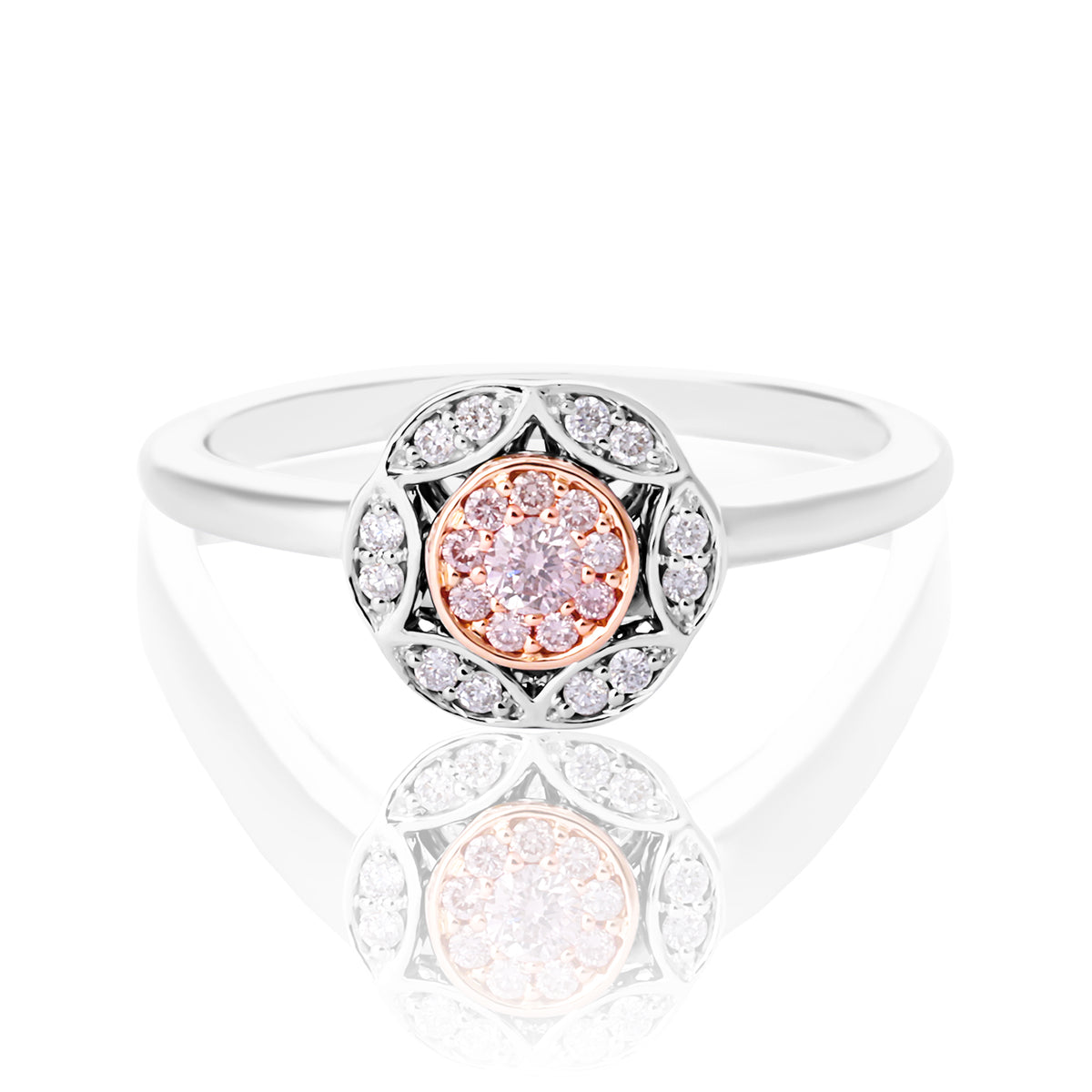 A white gold and rose gold ring with a central round rose gold gemstone surrounded by a halo of small clear stones, set against a white background with a soft reflection below.