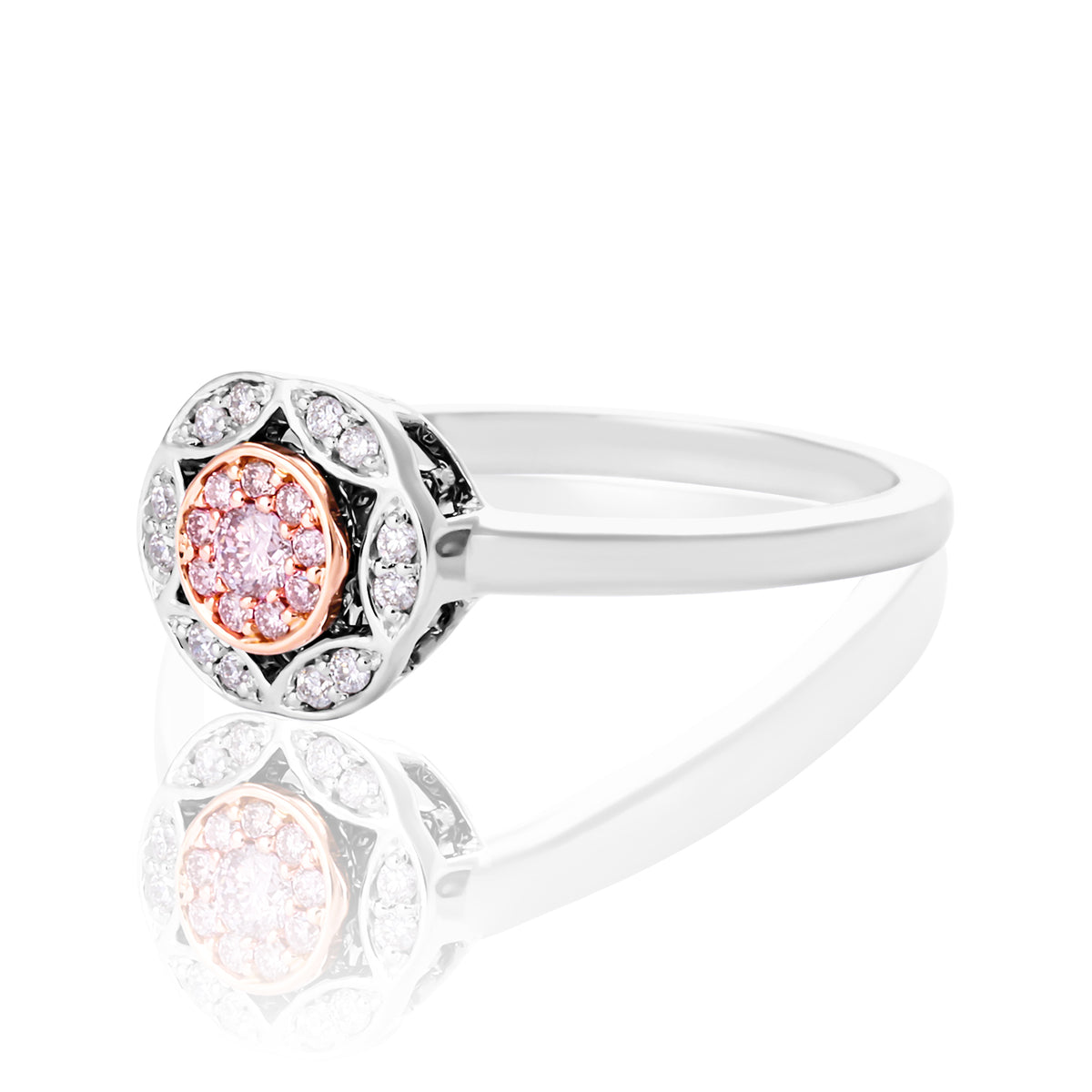 A halo ring featuring a central rose gold cluster of round-cut pink stones surrounded by clear stones, shown on a reflective white background.