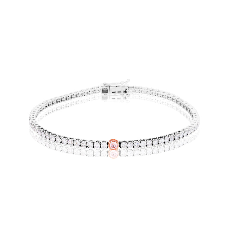 A tennis bracelet featuring a single rose gold oval center stone, displayed on a clean white background with a soft reflection.
