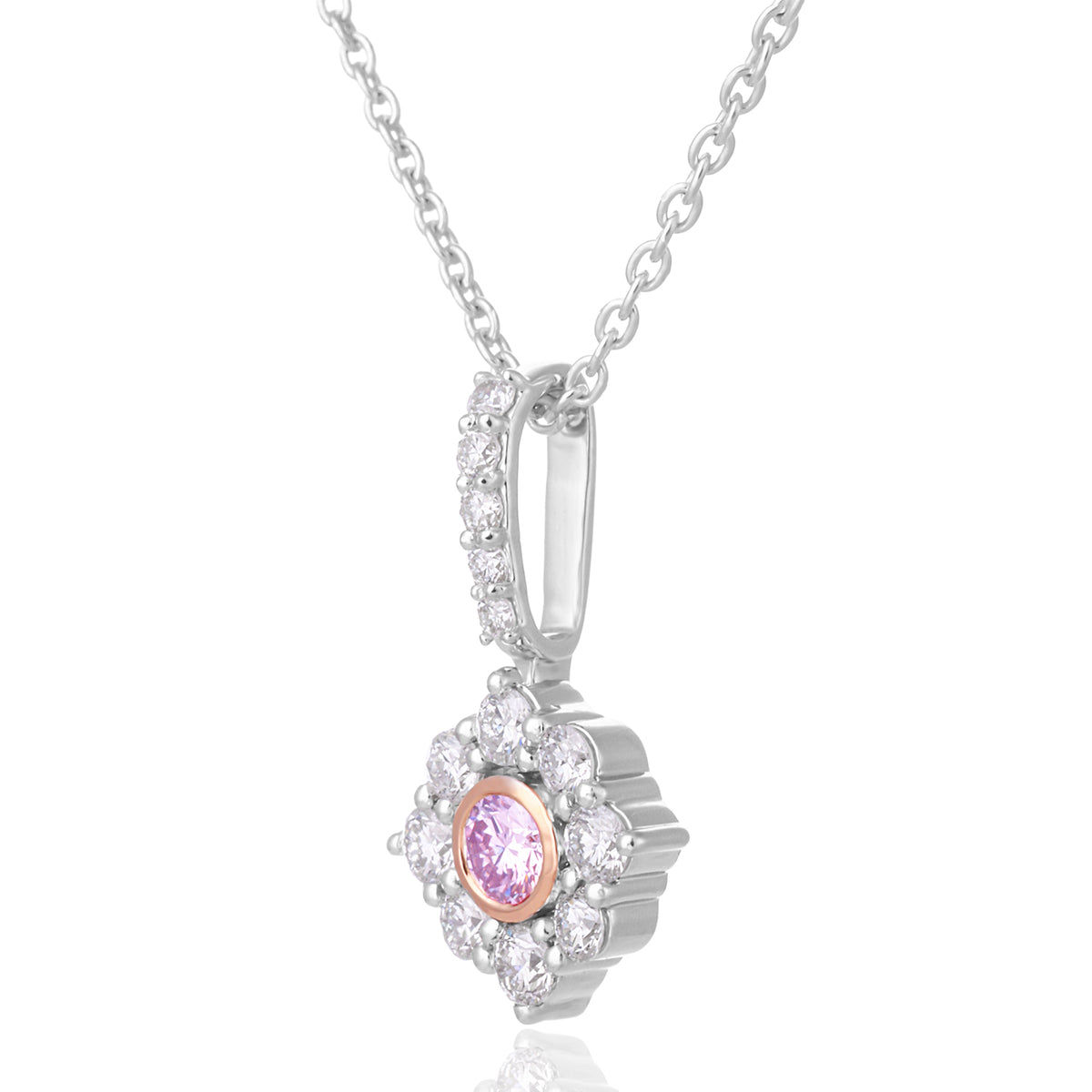A silver pendant necklace featuring a central round pink gemstone surrounded by a halo of small clear stones, suspended from a delicate silver chain on a white background.