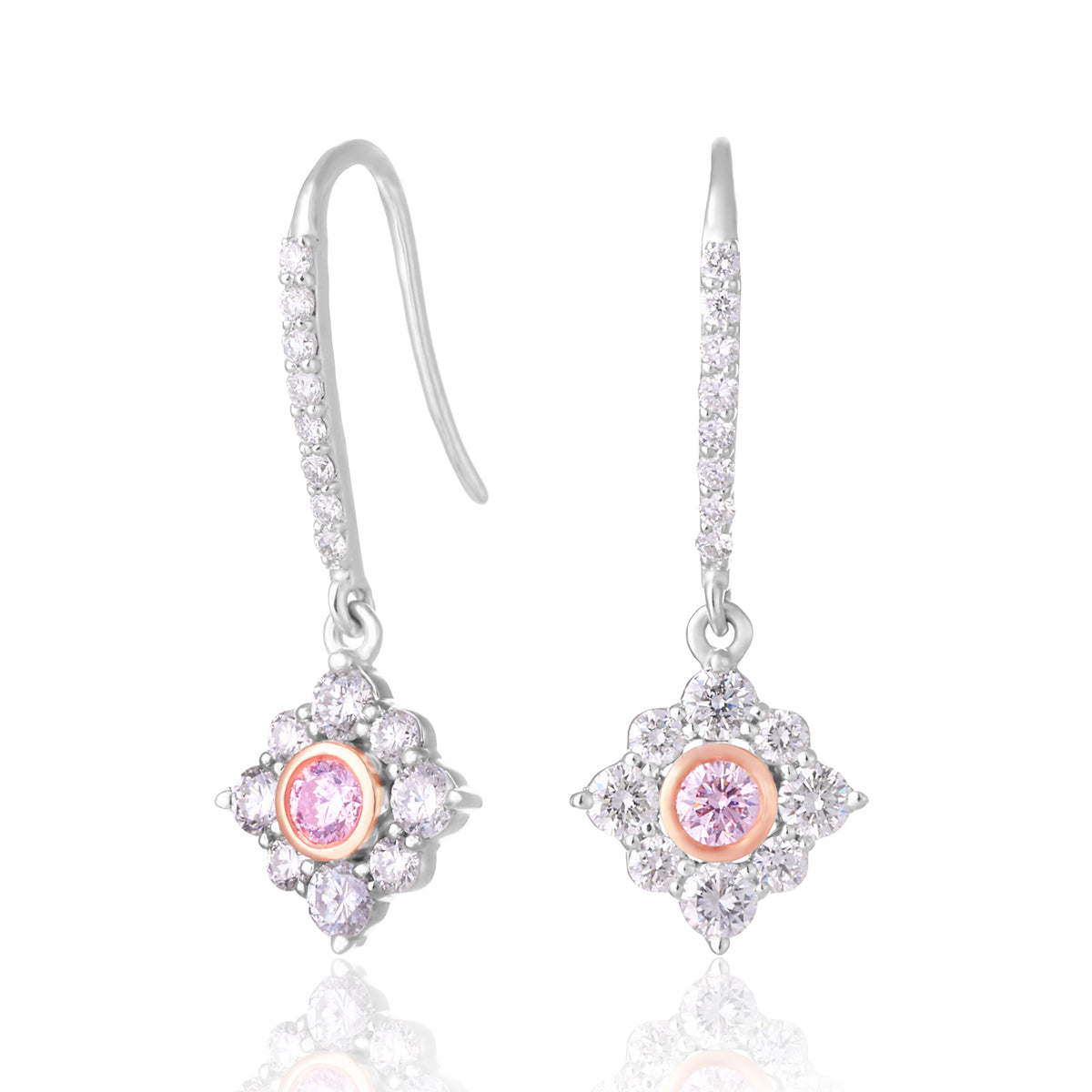 A pair of silver drop earrings with pavé diamond clusters, each featuring a central round pink gemstone, shown on a white background with a soft reflection.